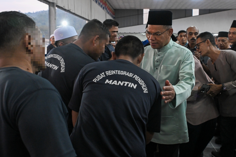 Home Minister Datuk Seri Saifuddin Nasution Ismail with inmates at the Mantin Inmate Reintegration Centre in Nilai, February 24, 2026. — Bernama pic 