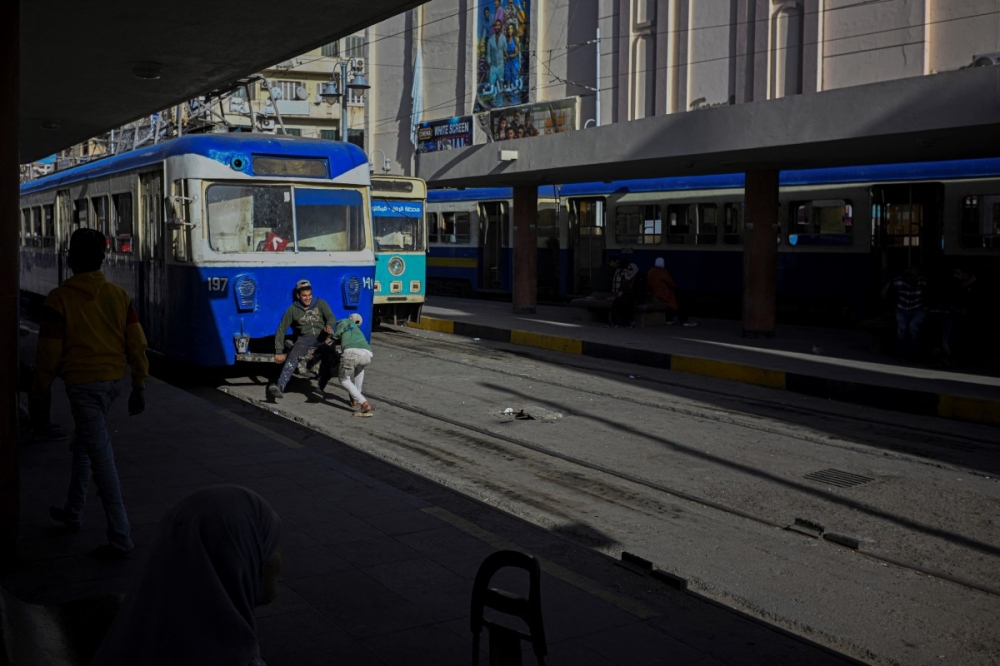 Youths play on the tram tracks in the coastal city of Alexandria on February 18, 2026. — AFP pic