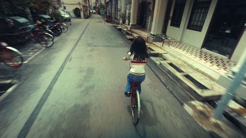 The waitress cycling down Stewart Lane. — Picture courtesy of Self-Portrait