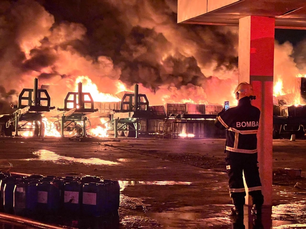 Firefighters continue efforts to extinguish a blaze at a rubber and plastic storage warehouse in the Sengkang Industrial Area along Jalan Air Hitam in Senai, Kulai, February 25, 2026. — Picture courtesy of the Johor Fire and Rescue Department