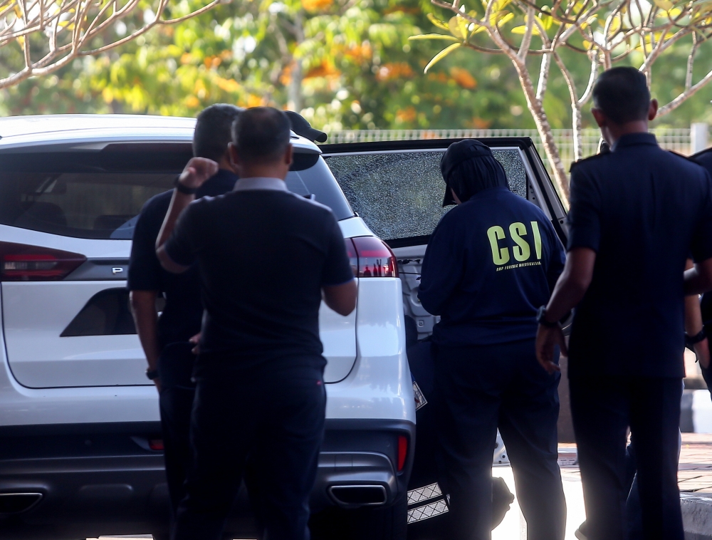 Police investigators examine Bukit Kayu Hitam AKPS commander SAC Mohd Nasaruddin Mohd Nasir’s car after it was fired upon in the early hours of February 25, 2026. — Bernama pic