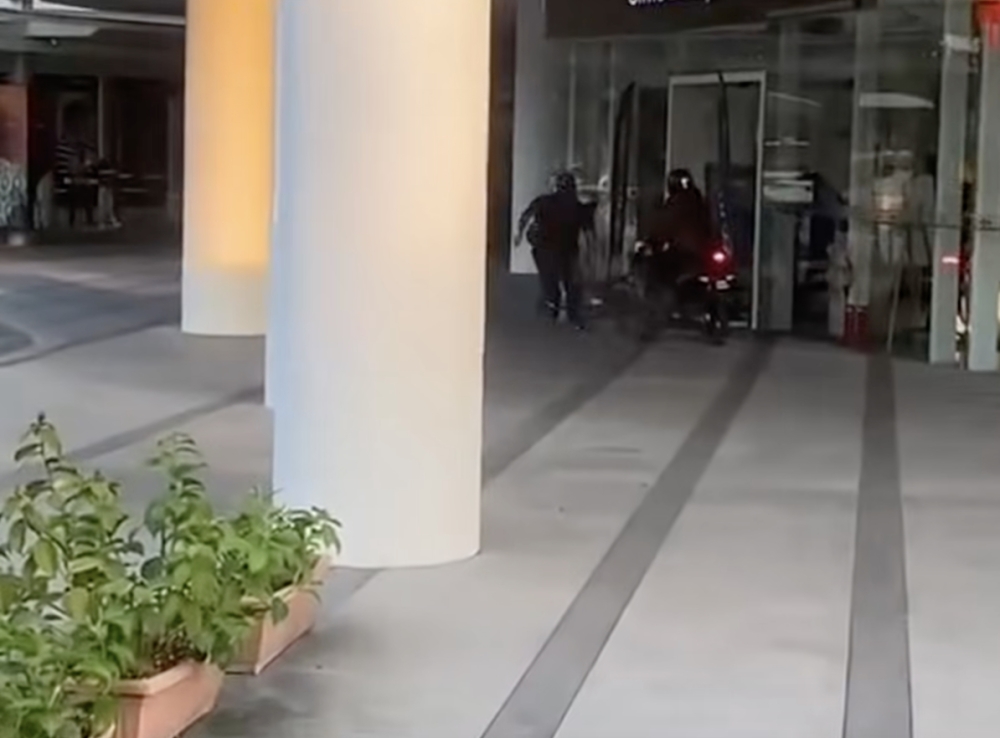 A 33-year-old man was seriously injured after he was slashed by several assailants outside a George Town shopping mall. Police have launched a manhunt. — Screengrab from Facebook video