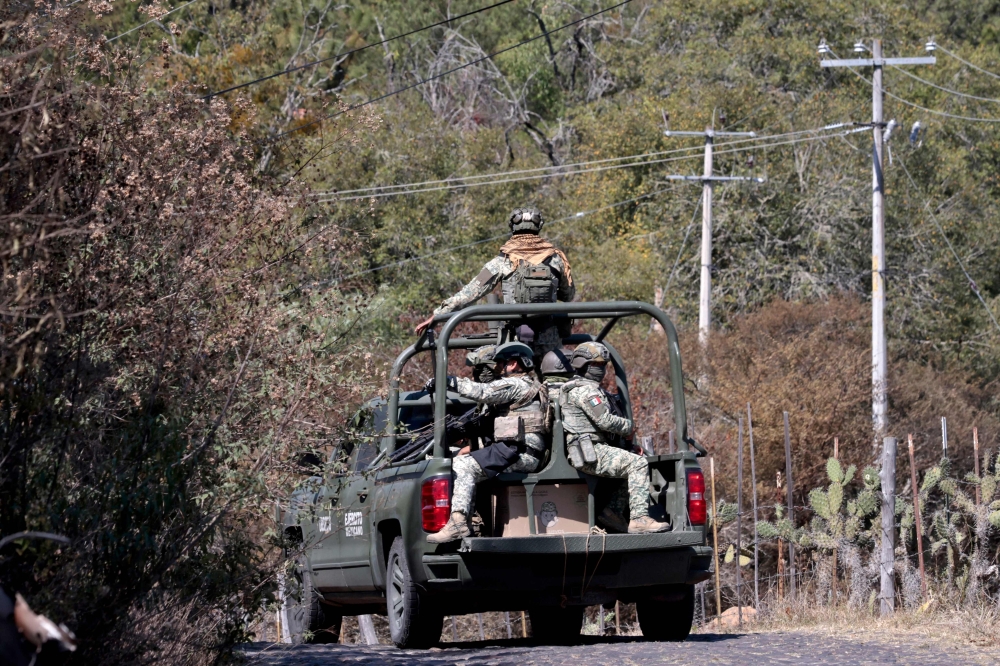 Army members drive trucks near the Tapalpa Country Club, where Mexican drug lord El Mencho was hiding during the operation in which he was killed, in Tapalpa, Jalisco state, Mexico, February 24, 2026. Residents cautiously emerged a day earlier after waves of retaliatory cartel violence rocked the state following the kingpin’s death. — AFP pic