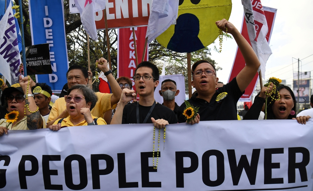 Activists and members of religious groups march towards the People Power monument during an anti-corruption protest to coincide with the commemoration of the 40th anniversary of People Power Revolution in Quezon City, suburban Manila on February 25, 2026. — AFP pic