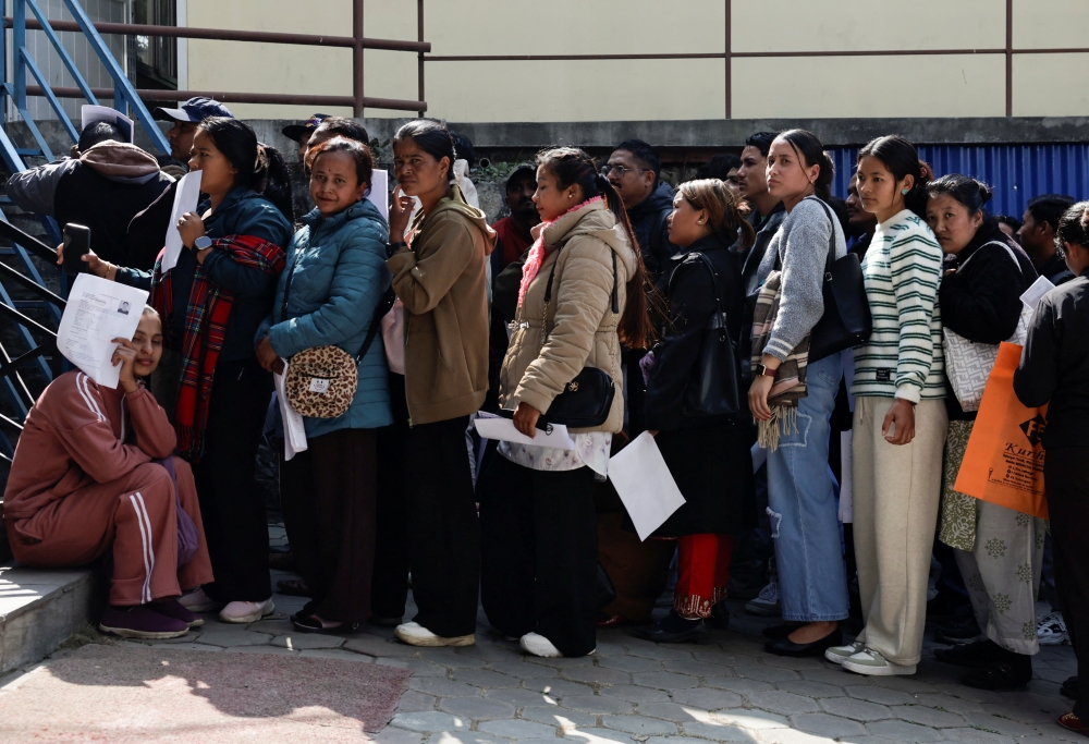 People planning to leave the country and apply for foreign employment in search of better opportunities queue as they prepare for an interview at Motherland Overseas, a recruitment agency, as Nepal’s biggest political parties vow to fix the outflow of workers ahead of the elections of the House of Representatives scheduled for March 5, triggered by historic youth-led protests fuelled by the lack of jobs and endemic corruption that forced an elected prime minister to resign, in Kathmandu, Nepal, February 22, 2026. — Reuters pic 