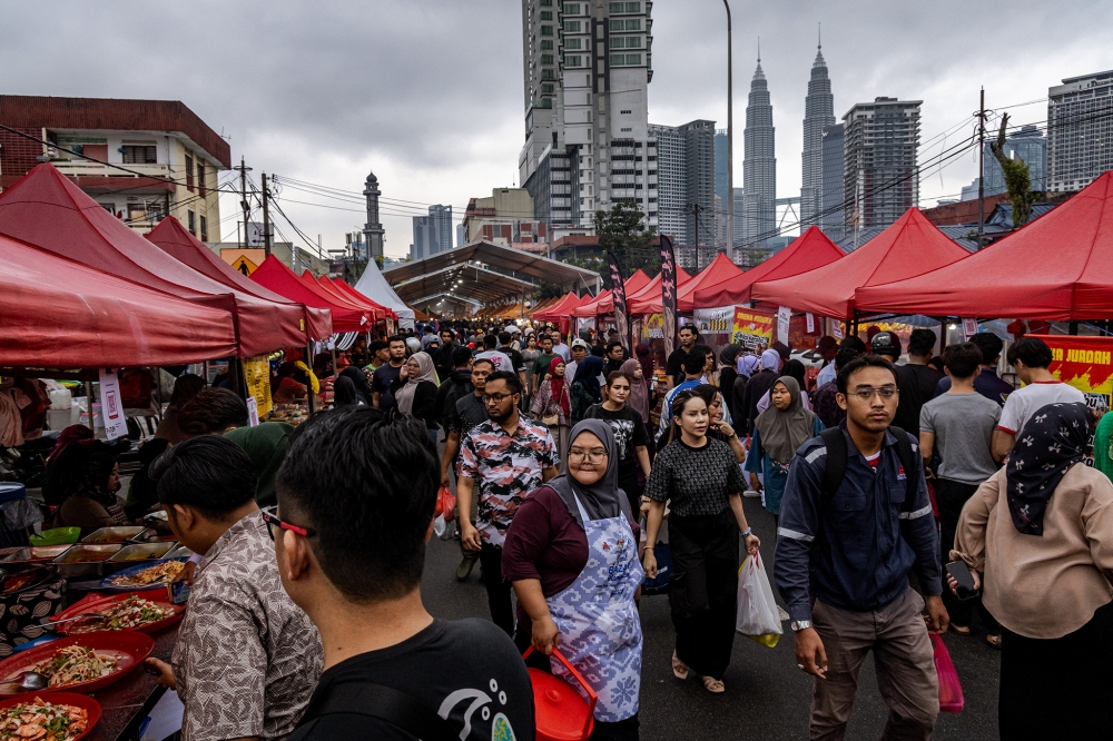 People look for food as they prepare to break their fast during the holy month of Ramadan at Kampung Baru, February 25, 2026. — Picture by Firdaus Latif