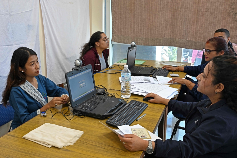 Youths register themselves for the upcoming Nepal’s parliamentary elections, in Kathmandu on October 13, 2025. Overseas Nepali workers bankroll their families and buttress the economy, making them a key constituency in elections, but they cannot vote themselves. — AFP pic 