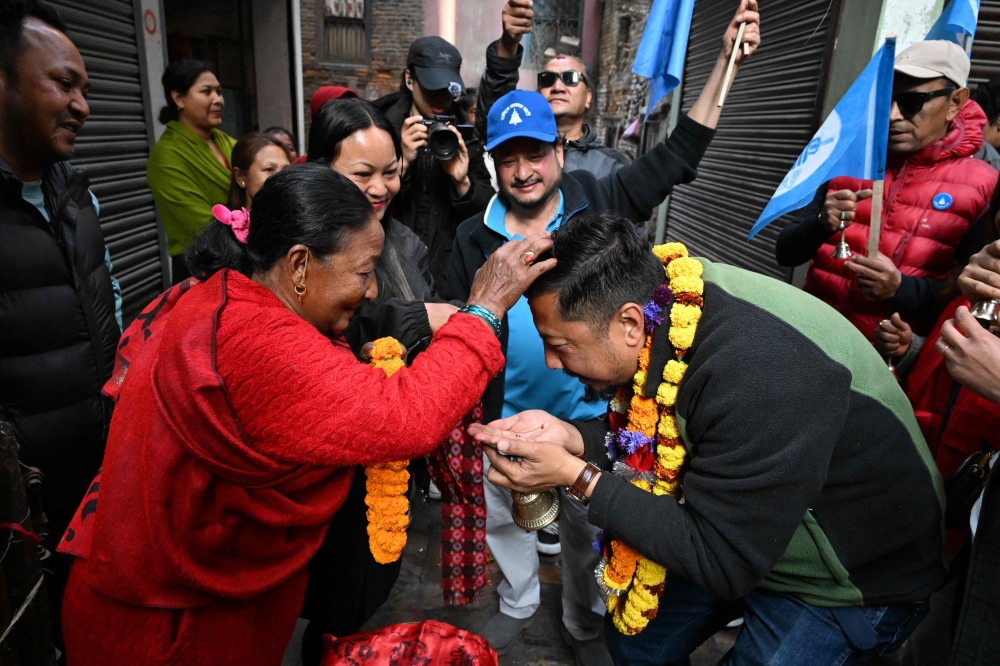 Rastriya Swatantra Party (RSP) election candidate Biraj Bhakta Shrestha greets supporters during door-to-door campaign in Kathmandu on February 20, 2026. — AFP pic 