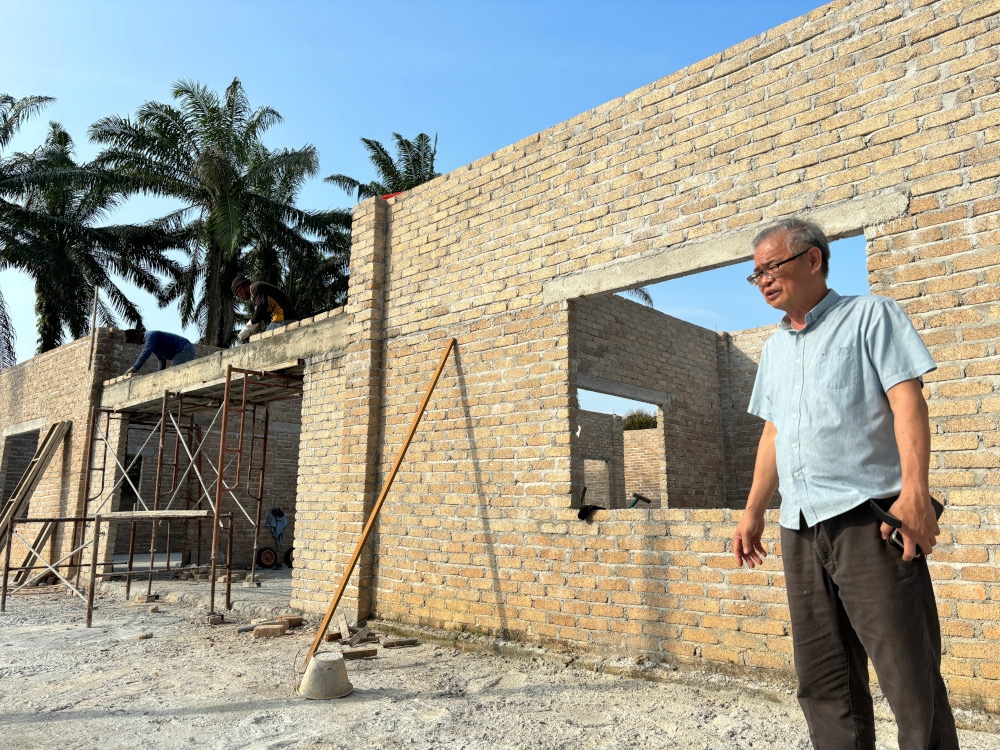Heartfield Sanctuary owner Wong Kim Fah, 61, showing the construction taking place at the sanctuary to expand its capacity to accommodate more visitors in Gopeng, Perak. — Picture by John Bunyan