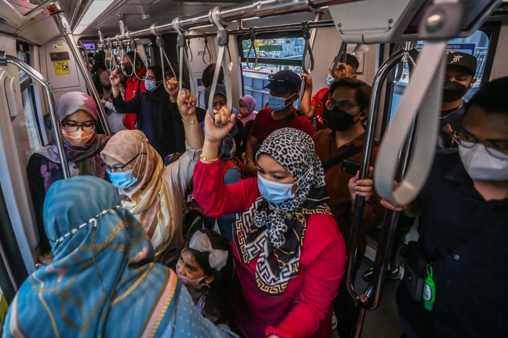 Commuters are pictured inside a Light Rail Transit (LRT) train in Kuala Lumpur on June 18, 2022. — Picture by Hari Anggara