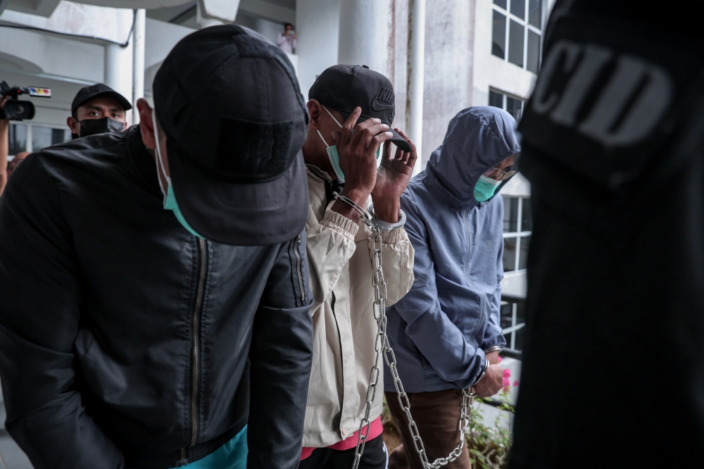 Malaysian Armed Forces trainers Major Mohd Azmi Abu Bakar (right), Warrant Officer Mohd Norbuang Ghani (centre), and Captain Muhammad Bahaudin Abd Rashid (left), are brought to the Sessions Court in Kota Tinggi on February 27, 2026. — Bernama pic