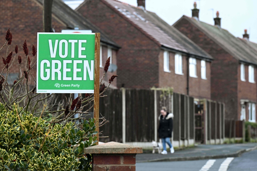 A poster promoting Britain's Green party is pictured outside a residential property in Denton, Greater Manchester on February 12, 2026, as parties begin to canvas voters ahead of the crucial Gorton and Denton by-election. — AFP pic 