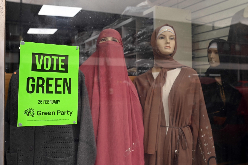 A poster promoting Britain's Green party is pictured in the window of a clothes retailer in Longsight, Greater Manchester on February 12, 2026, as parties begin to canvas voters ahead of the crucial Gorton and Denton by-election. — AFP pic 