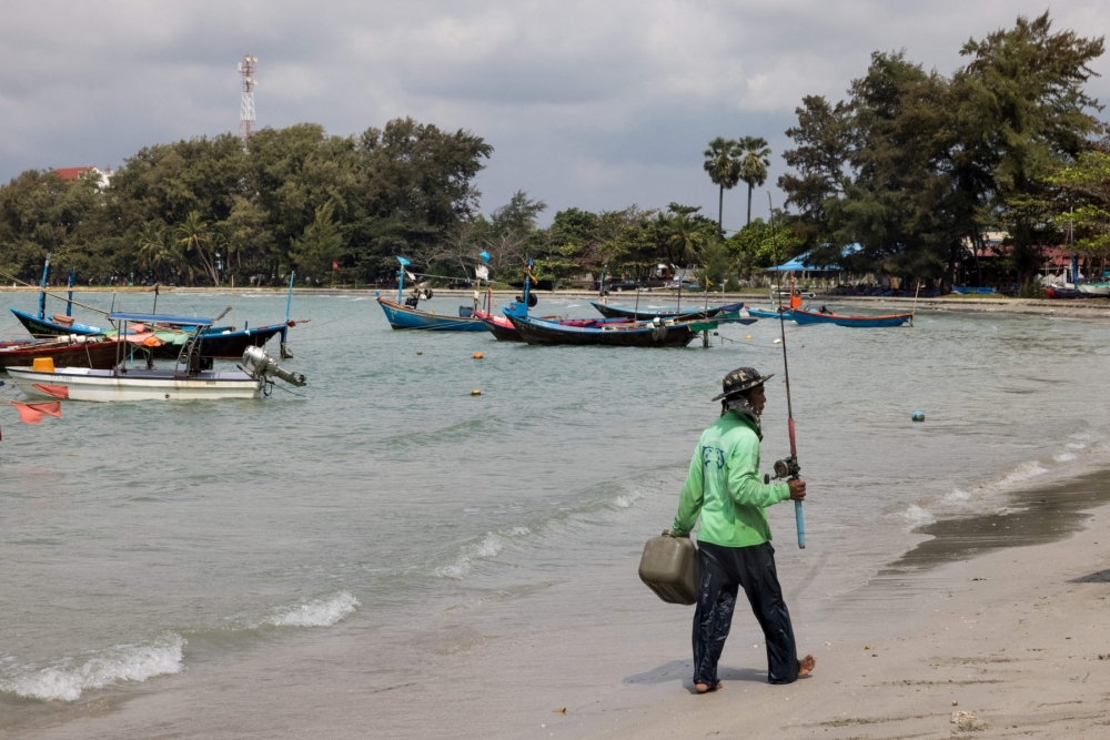 A fishermen returns to Mae Ram Phueng beach following a January 25 crude oil spill off the coast caused by a leak in an undersea pipeline owned by Star Petroleum Refining Public Company Limited in Rayong on January 30, 2022. — AFP pic 
