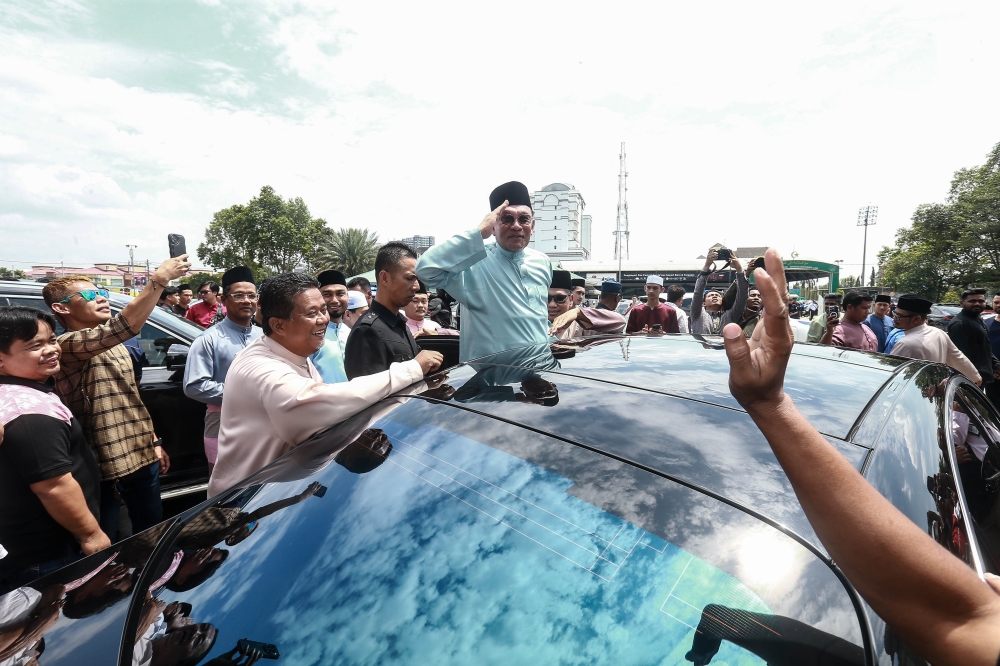 Prime Minister Datuk Seri Anwar Ibrahim greets the congregation as he arrives for Friday prayers at Masjid Jamek Bandar Kajang in Kajang on February 27, 2026. — Picture by Sayuti Zainudin