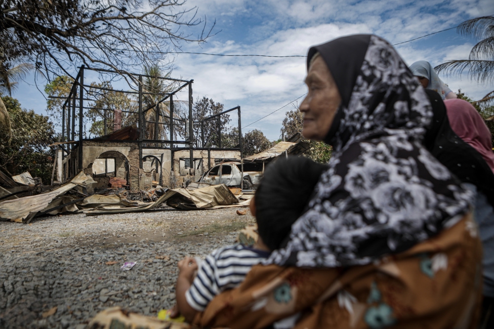 Salleh Manis, 76, sits in front of his house at Kampung Sungai Padang, Simpang Empat that was destroyed in a fire on February 26, 2026, leaving his family with losses estimated at RM70,000. — Bernama pic