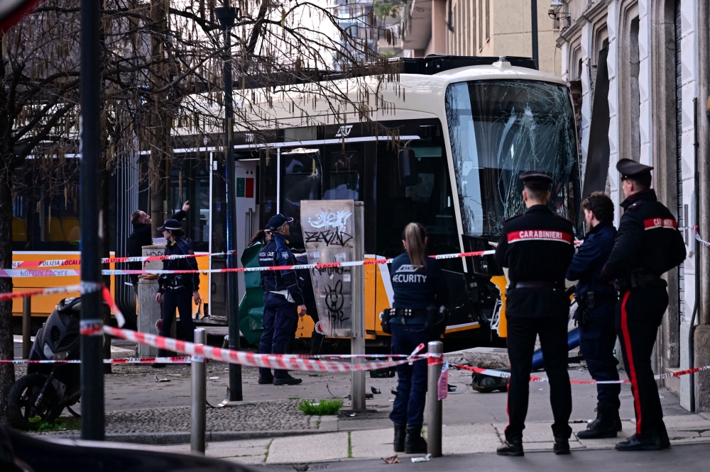 Italian police officers stand at the site of a tram derailment in Milan on February 27, 2026. A tram derailed and smashed into a building in Milan today, killing one person and injuring around 20 others, the police told AFP. — AFP pic 