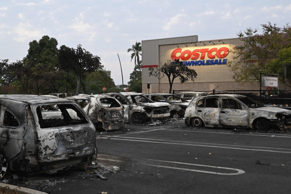 Burnt cars are in the parking lot of a Costco retail store in Puerto Vallarta, Jalisco state, Mexico on February 23, 2026. — AFP pic