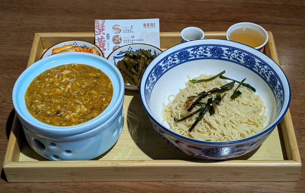 Each order comes with ‘kimchi’, pickled green beans, a shot of vinegar, ginger tea, handmade wheat noodles and the crab roe and meat sauce. — Picture by Ethan Lau