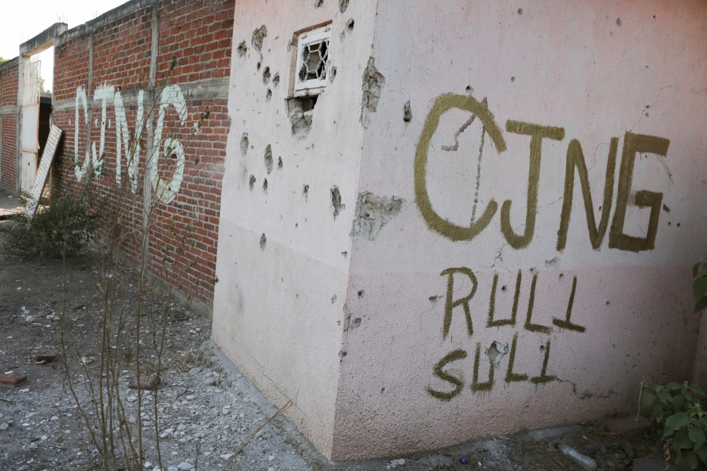 A bullet-riddled facade with the acronym of the Jalisco New Generation Cartel (CJNG) is pictured at an area where the Jalisco New Generation Cartel (CJNG) and local drug gangs are fighting to control the territory, in El Aguaje, Michoacan state, Mexico April 23, 2021. — Reuters pic