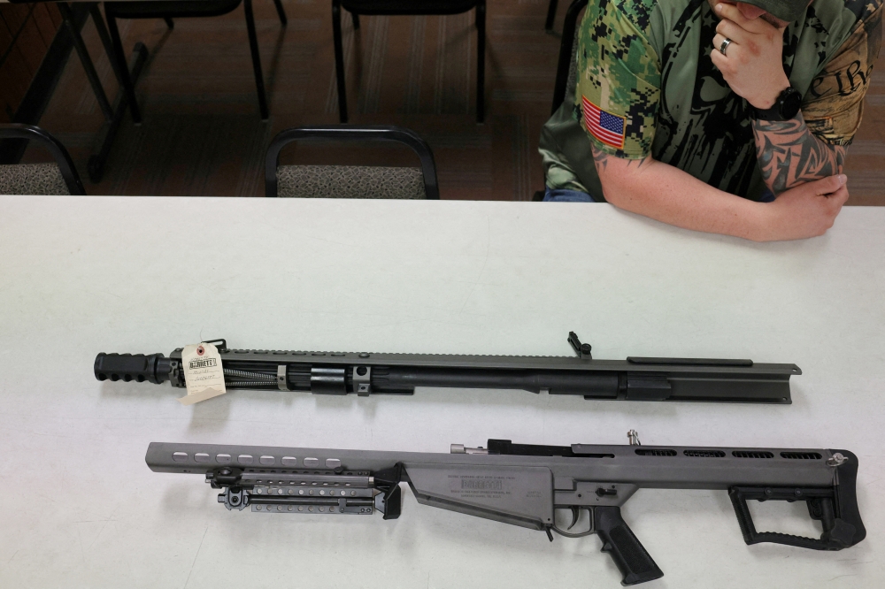 An employee shows a .50‑caliber Barrett M107A1 semi‑automatic rifle to Reuters at a gun store after US officials accused members of the Cobian family of purchasing, and recruiting others to purchase .50‑caliber Barrett sniper rifles that were then smuggled to the Jalisco New Generation Cartel (CJNG) in Mexico, in Racine, Wisconsin June 26, 2023. — Reuters pic
