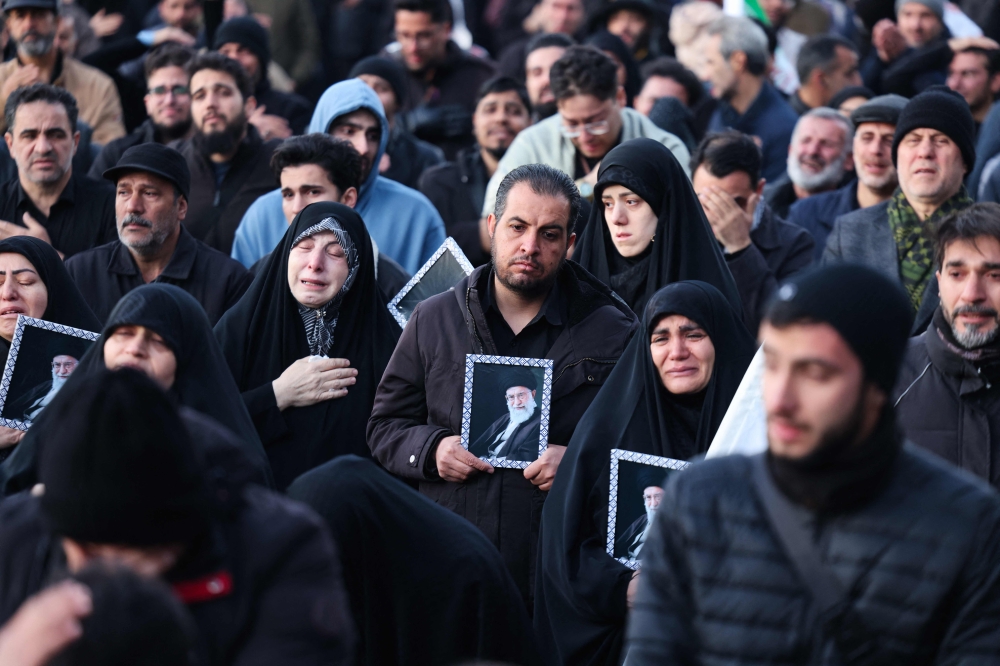 People mourn the death of Iran’s supreme leader Ayatollah Ali Khamenei, who was killed in joint US and Israeli strikes, at a square in Tehran on March 1, 2026. — AFP pic