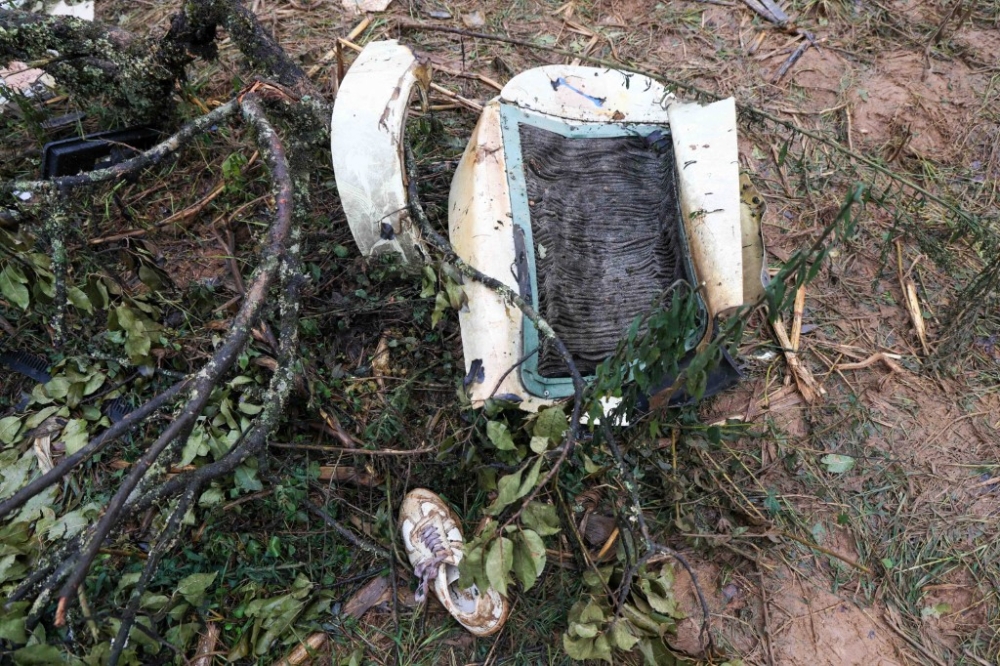 People inspect the wreckage at the crash site after a helicopter accident in Nandi County, located in Kenya’s North Rift region, killed six people, including Kenyan Member of Parliament Johana Ng’eno and the pilot, on March 1, 2026. — Lucas Mukasa/Anadolu/AFP pic