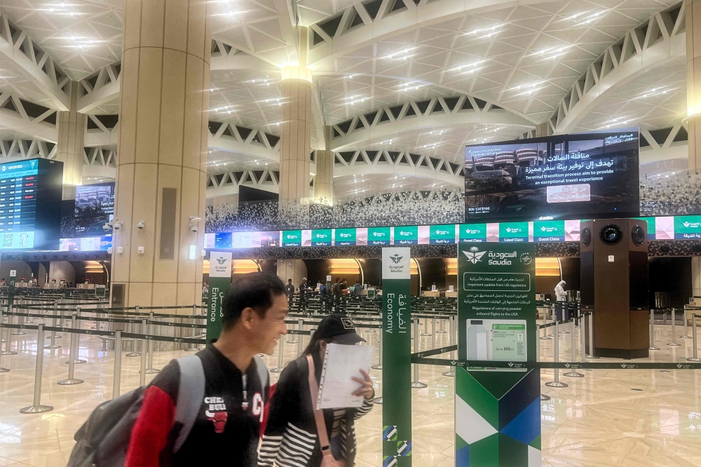 Travellers walk at the empty terminal at King Khalid International Airport in Riyadh on March 1, 2026. — AFP pic 
