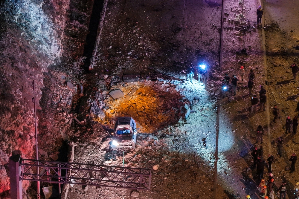 A drone view of Israeli emergency responders working at the scene of an Iranian missile strike on a road, after Iran launched missile barrages following attacks by the U.S. and Israel, in Jerusalem March 1, 2026. — Reuters pic