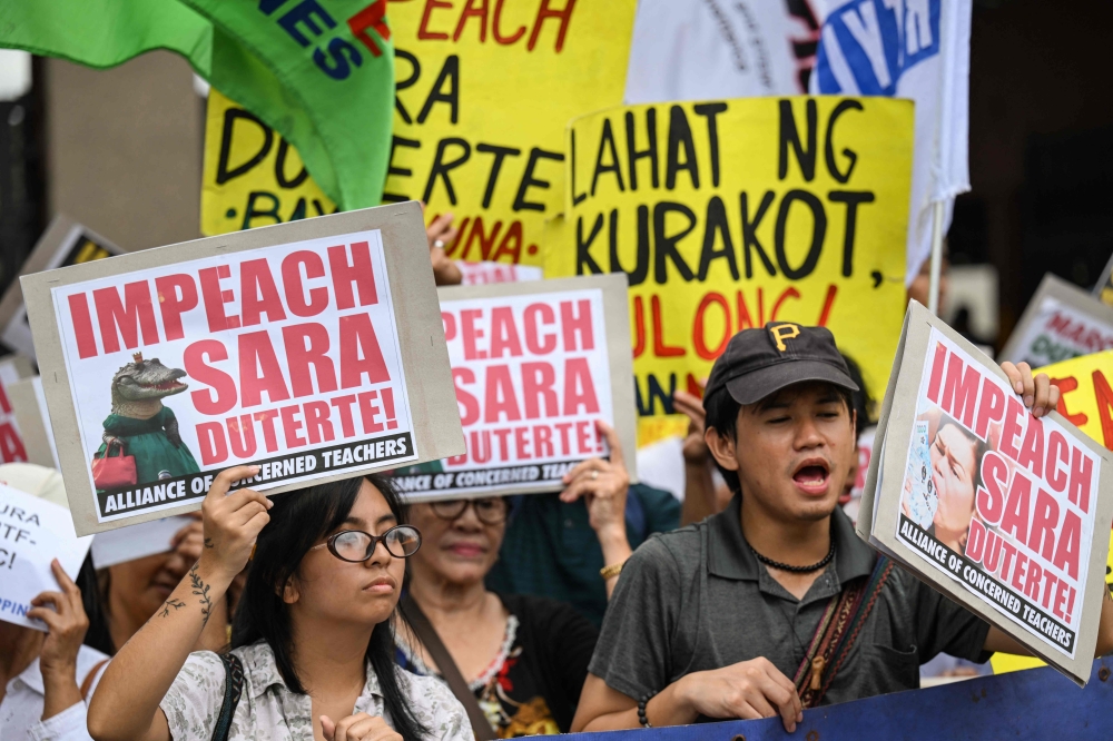 Protesters call for the impeachment of Philippine Vice President Sara Duterte outside the House of Representatives in Quezon City, Metro Manila on March 2, 2026. A Philippine congressional committee began impeachment hearings today that could end Vice President Sara Duterte's presidential dreams as quickly as they began. — AFP pic 