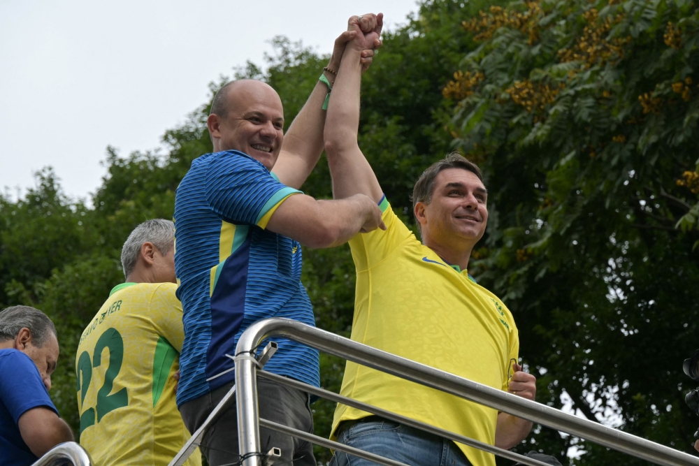 Senator and presidential candidate Flavio Bolsonaro (right) gestures to supporters of Brazil's former president Jair Bolsonaro (2019-2022), sentenced to 23 years and 3 months for attempted coup, during a demonstration in Sao Paulo, Brazil, on March 1, 2026. — AFP pic 