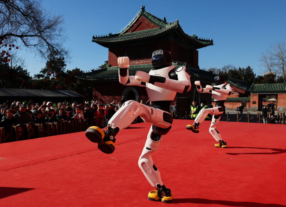 People watch as robots perform a dance during Lunar New Year celebrations marking the Year of the Horse, in Beijing February 18, 2026. — Reuters pic 