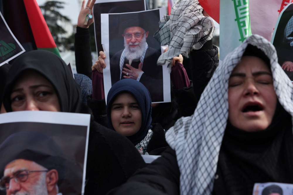 Demonstrators carrying pictures of late Iran’s Supreme Leader Ayatollah Ali Khamenei take part in a protest against Israel and the US strikes on Iran near the Israeli consulate in Istanbul, Turkey on March 1, 2026. — Reuters pic