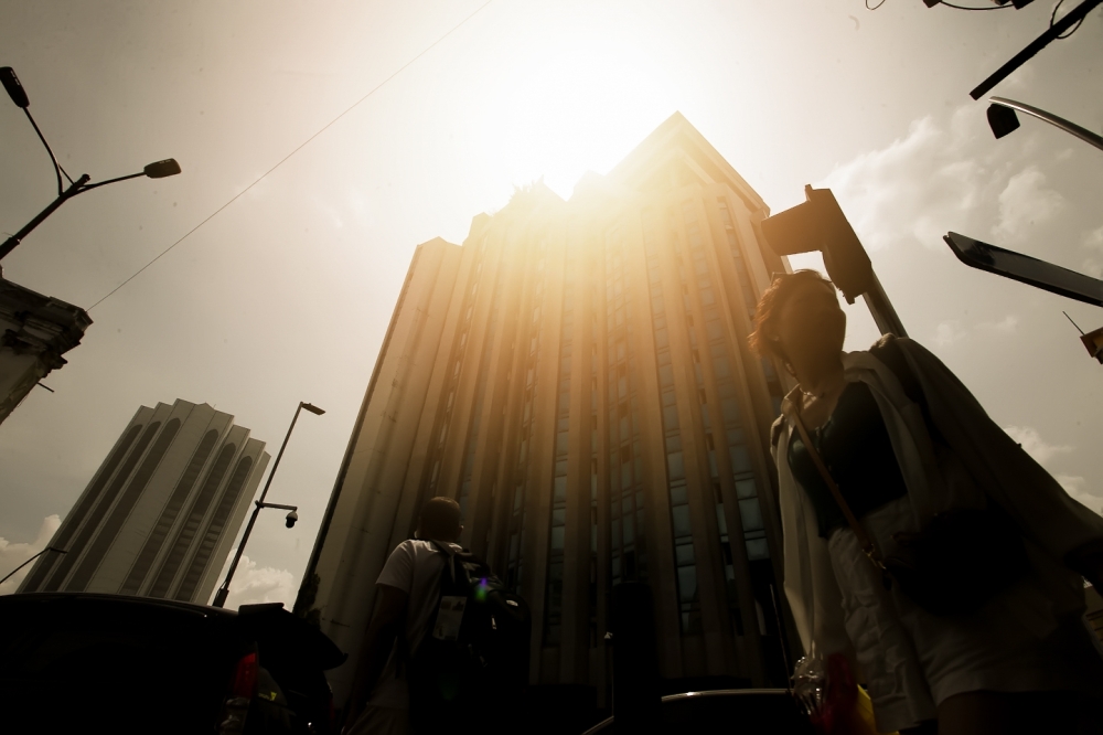 A pedestrian walks under the scorching sun in Kuala Lumpur on May 23, 2023. — Picture by Raymond Manuel