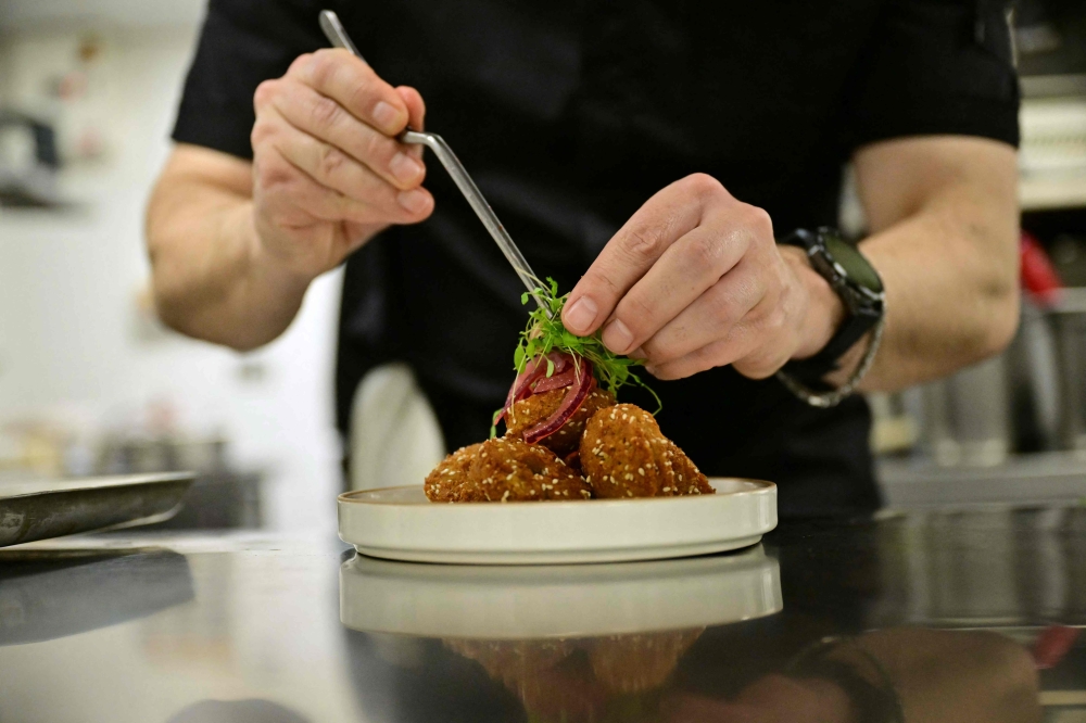 Imad Alarnab, a chef and restaurant owner who fled Syria in 2015, works at one of his restaurants in central London on February 4, 2026. — AFP pic