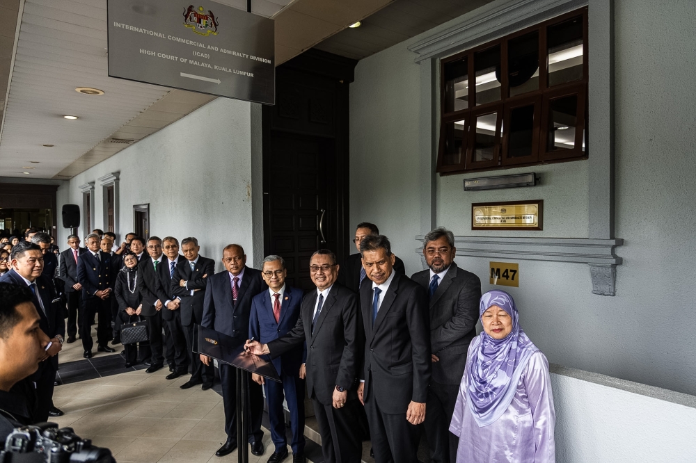 Chief Justice Datuk Wan Ahmad Farid Wan Salleh signs the commemorative plaque at the ICAD launch in Kuala Lumpur. — Picture by Firdaus Latif
