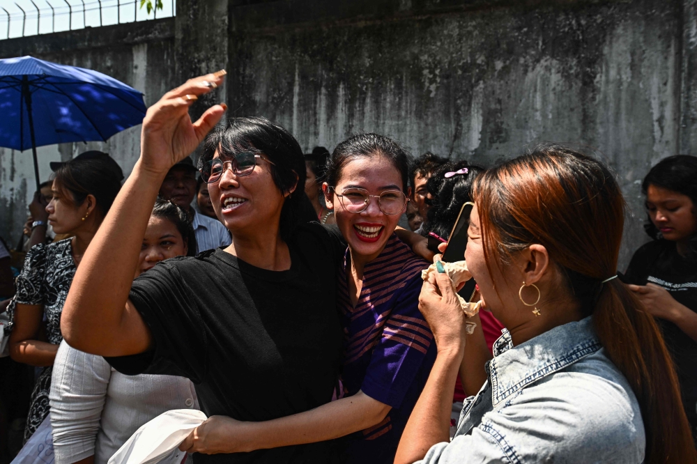 Relatives celebrate with a family member after she was released from Insein prison in Yangon on March 2, 2026 to mark Peasants' Day. Myanmar's military junta on March 2 announced amnesties for more than 7,000 prisoners convicted of financing or sheltering a ‘terrorist group’, a designation it has used to outlaw pro-democracy factions opposing its rule. — AFP pic