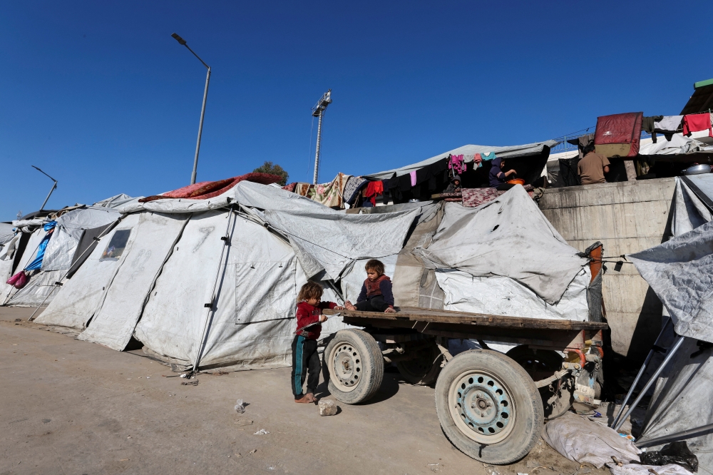 Palestinian children displaced during the two-year Israeli offensive, play as they shelter at a tent camp in Gaza City, March 1, 2026. — Reuters pic