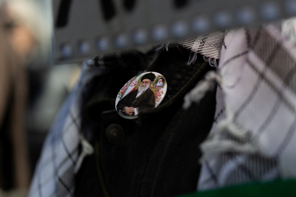 A protester wears a badge depicting late Iran’s Supreme Leader Ayatollah Ali Khamenei during an anti-war demonstration following strikes on Iran, in Athens March 1, 2026. — Reuters pic
