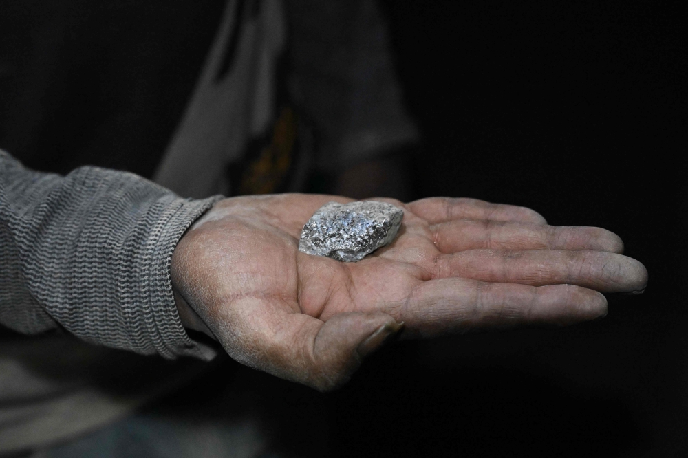 A miner shows a piece of silver inside a tunnel of the Rosario Bajo Cooperativa Minera on Cerro Rico, in the Potosi Department, in southern Bolivia on February 19, 2026. — AFP pic