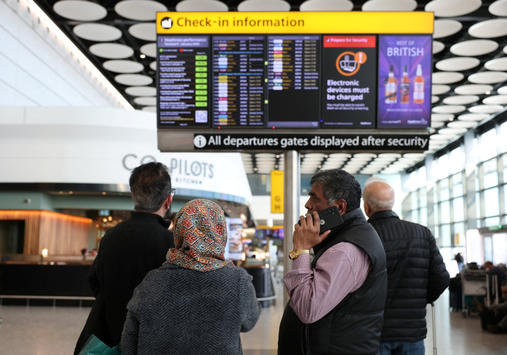Travellers check on a departure board displaying cancelled flights to Middle East countries amid the US-Israel conflict with Iran, at Heathrow Airport Terminal 4, in London March 2, 2026. — Reuters pic