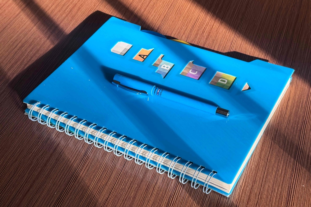 The private blue notebook of an Afghan woman who teaches girls and young women online is seen in a closet inside a house in Afghanistan on February 25, 2026. — AFP pic