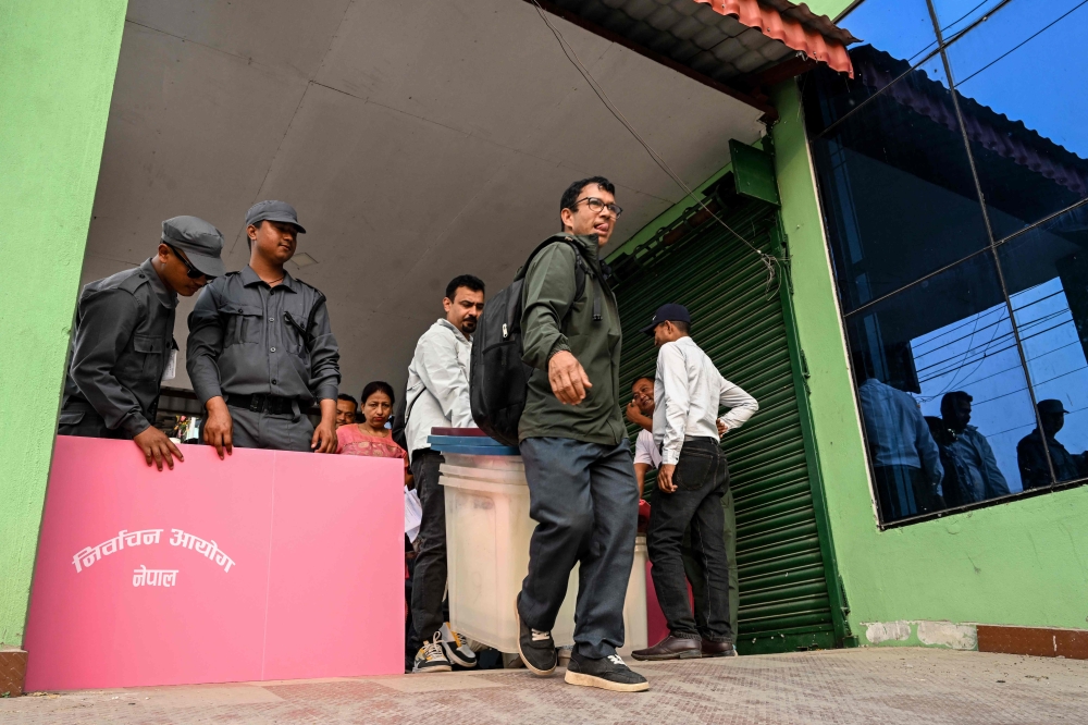 Polling officials carry ballot boxes and other materials at Damak in Jhapa district on March 2, 2026, ahead of the general elections in Nepal. — AFP pic