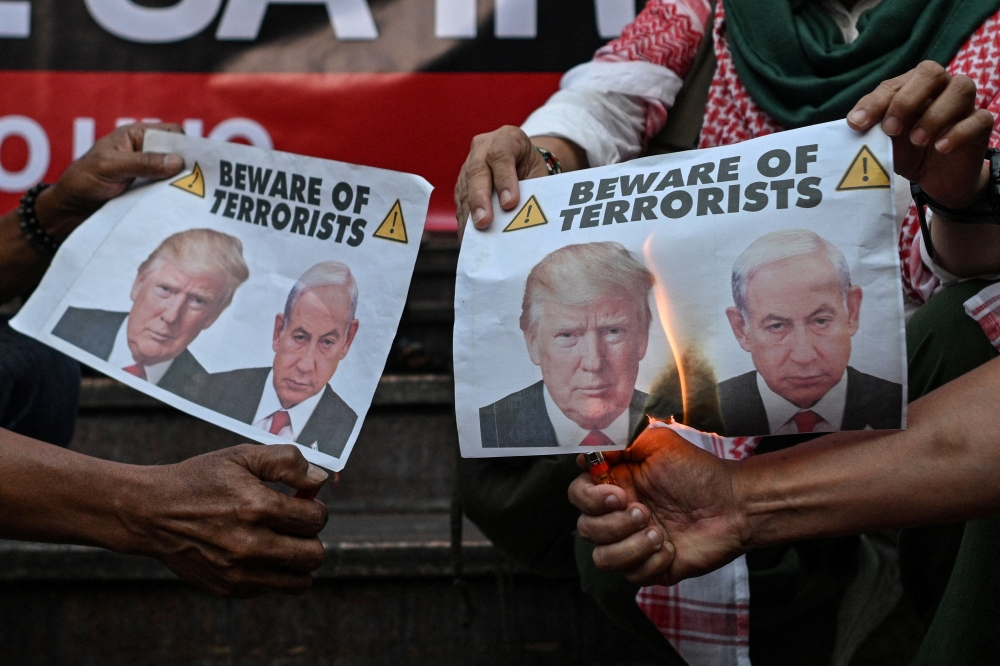 Protesters burn pictures of US President Donald Trump and Israeli Prime Minister Benjamin Netanyahu during a rally, following strikes by the US and Israel on Iran and the killing of Iran’s Supreme Leader Ayatollah Ali Khamenei, in Quezon City, Metro Manila, Philippines, March 2, 2026. — Reuters pic