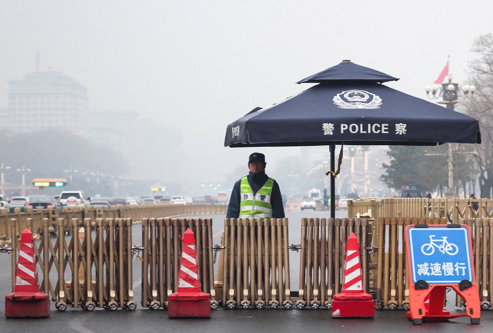A police officer stands guard at a checkpoint at Changan Avenue on a foggy day ahead of the annual meeting of the National People’s Congress, which starts this week, in Beijing March 2, 2026. — Reuters pic