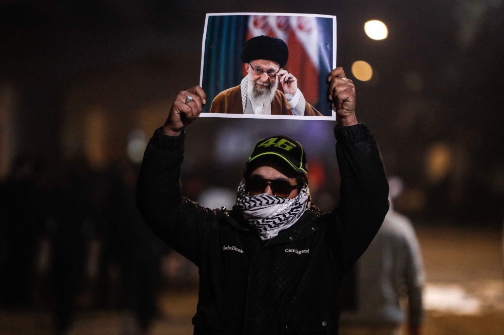 A protester holds up a portrait of Iran’s slain supreme leader Ali Khamenei during a demonstration in support of the Iranian regime at one of the entrances to Baghdad’s Green Zone, where the US embassy is located, late on March 2, 2026. — AFP pic