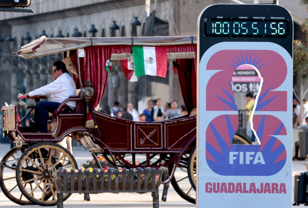 An electric carriage designed to resemble a horse-drawn vehicle moves past a countdown clock marking 100 days until the 2026 FIFA World Cup in Guadalajara, Jalisco state, Mexico, on March 2, 2026. — AFP pic