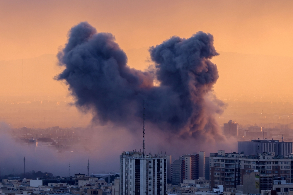 A plume of smoke rises after a strike on the Iranian capital Tehran, on March 3, 2026. Iran stepped up its attacks on economic targets and US missions across the Middle East yesterday as the US president warned it was ‘too late’ for the Islamic republic to seek talks to escape the war. — AFP pic 