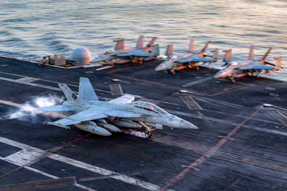 This US Navy handout photo released by US Central Command public affairs shows an F/A-18F Super Hornet, attached to Strike Fighter Squadron (VFA) 41, making an arrested landing on the flight deck of Nimitz-class aircraft carrier USS Abraham Lincoln (CVN 72) in support of Operation Epic Fury on February 28, 2026. The United States and Israel launched a wave of strikes against targets in Iran on February 28, sparking swift retaliation by the Islamic republic which responded with missile attacks across the region. — US Navy handout/AFP pic 