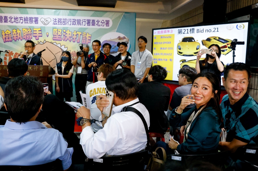 People react during Taiwan’s auction of luxury cars linked to the Cambodian scam centre Prince Group, in Taipei March 2, 2026. — Reuters pic 